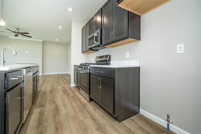 kitchen featuring appliances with stainless steel finishes, ceiling fan, light wood-style flooring, light countertops, and recessed lighting