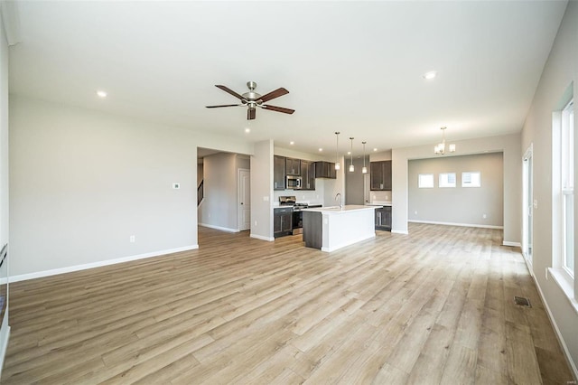 unfurnished living room with light wood-style floors, baseboards, and recessed lighting