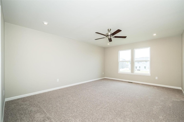 carpeted spare room featuring baseboards, ceiling fan, and recessed lighting