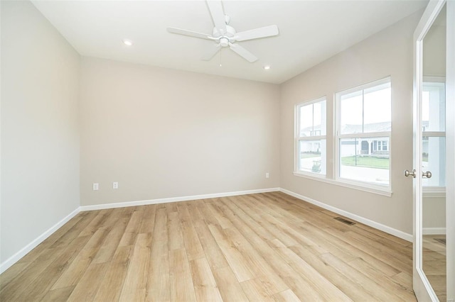 spare room featuring light wood-style floors, baseboards, ceiling fan, and recessed lighting