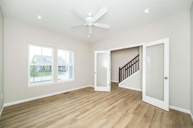 spare room with light wood-style floors, french doors, baseboards, ceiling fan, and recessed lighting
