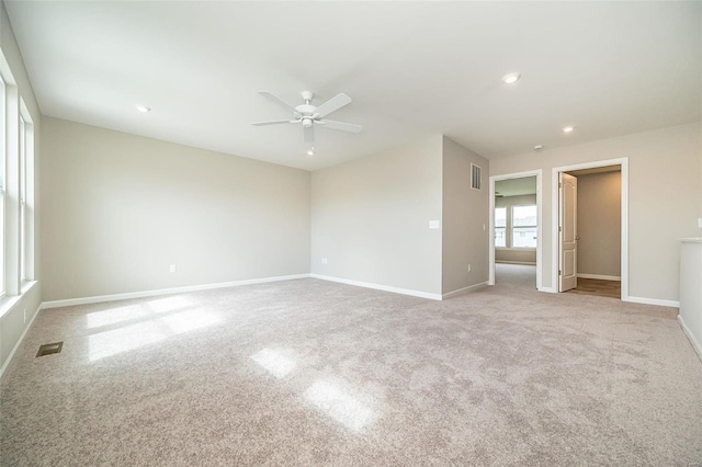 carpeted empty room featuring a ceiling fan, baseboards, and recessed lighting
