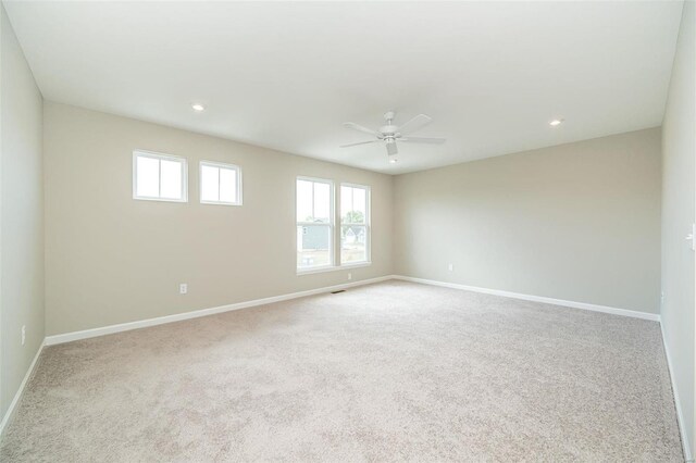carpeted empty room featuring ceiling fan, baseboards, and recessed lighting