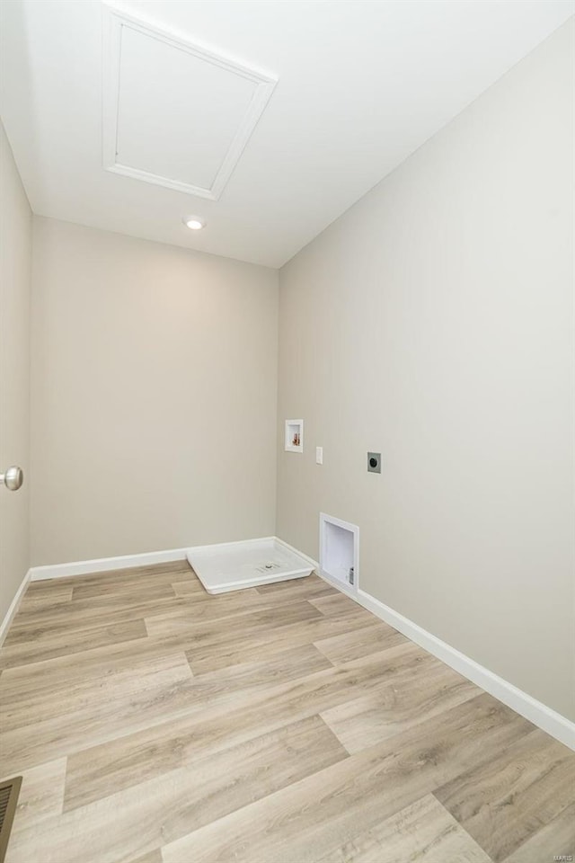 clothes washing area featuring electric dryer hookup, hookup for a washing machine, light wood-style floors, baseboards, and recessed lighting