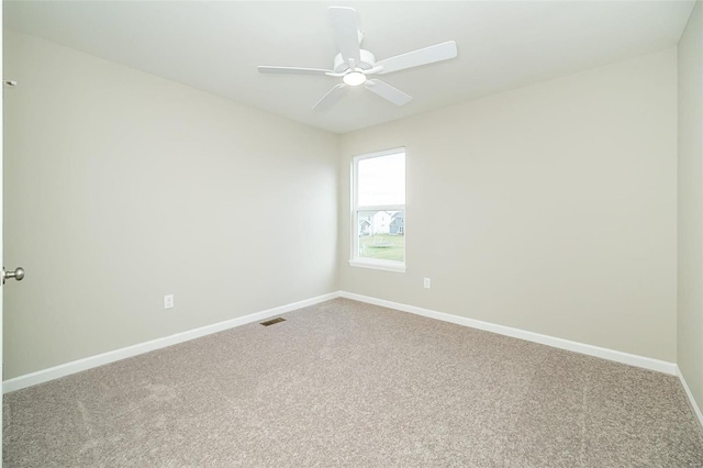 unfurnished room with carpet floors, baseboards, and a ceiling fan