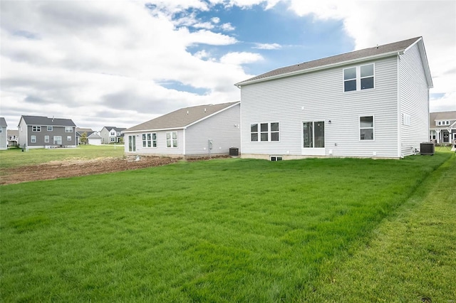 back of property featuring cooling unit and a lawn