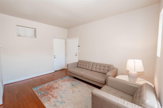 living area featuring wood finished floors and baseboards