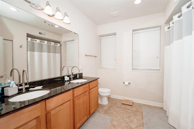 full bath featuring toilet, double vanity, baseboards, tile patterned floors, and recessed lighting