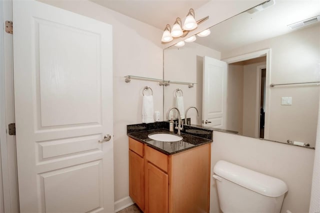 half bath featuring toilet and vanity