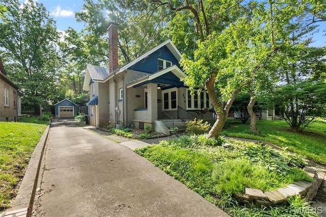 374 N Park Ave, Cape Girardeau, MO 63701 - bungalow-style home featuring asphalt driveway, an outbuilding, a porch, a chimney, and a detached garage