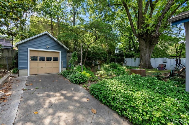 374 N Park Ave, Cape Girardeau, MO 63701 - detached garage with driveway and view of scattered trees