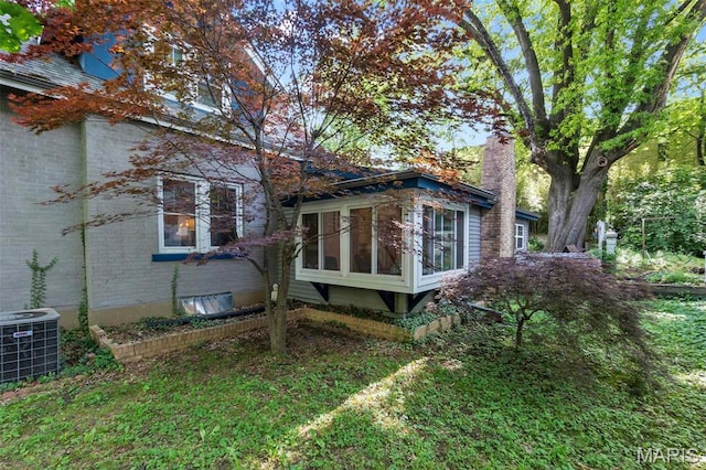 374 N Park Ave, Cape Girardeau, MO 63701 - view of property exterior with a sunroom, brick siding, and cooling unit