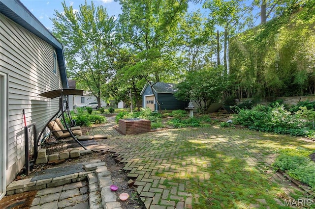 374 N Park Ave, Cape Girardeau, MO 63701 - view of yard featuring an outdoor structure and a patio area