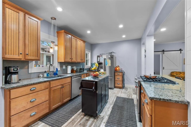 374 N Park Ave, Cape Girardeau, MO 63701 - kitchen featuring a sink, appliances with stainless steel finishes, light wood-style flooring, backsplash, and stone counters