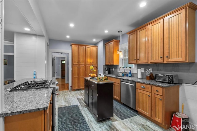 374 N Park Ave, Cape Girardeau, MO 63701 - kitchen with stainless steel appliances, a sink, light wood-type flooring, a center island, and brown cabinetry