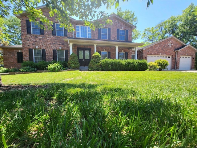 view of front of home featuring brick siding, an attached garage, and a front lawn