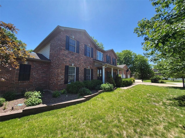 view of front of property with brick siding and a front yard