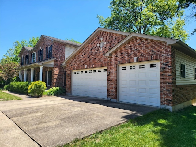 view of front of home with driveway, a garage, and brick siding