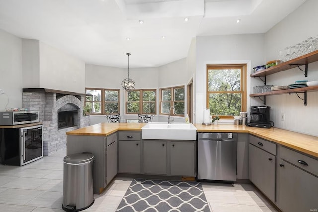 27302 Cimarron Dr, Roaring River Township, MO 65641 - kitchen featuring gray cabinets, appliances with stainless steel finishes, a sink, wood counters, and plenty of natural light