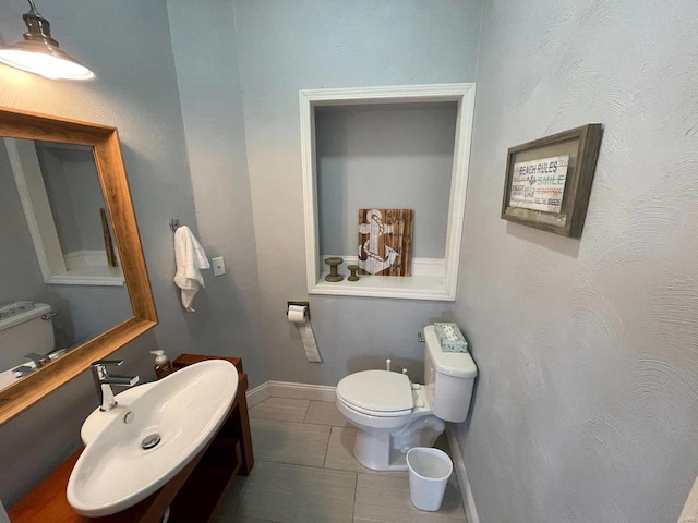 27302 Cimarron Dr, Roaring River Township, MO 65641 - bathroom featuring toilet, a sink, tile patterned flooring, and baseboards