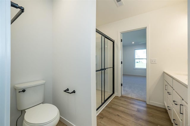 1909 Rolling River Cir, Ofallon, MO 63366 - full bathroom with a shower stall, wood finished floors, vanity, baseboards, and toilet