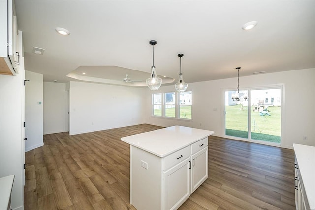 1909 Rolling River Cir, Ofallon, MO 63366 - kitchen with open floor plan, a chandelier, light countertops, white cabinetry, and light wood finished floors