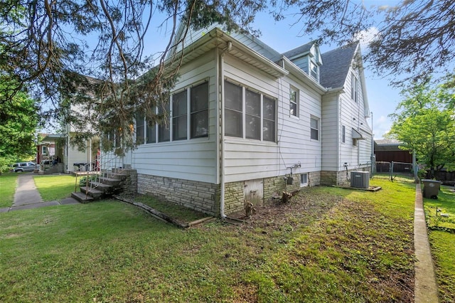 view of home's exterior featuring cooling unit and a sunroom