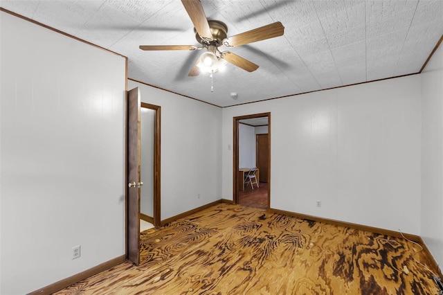 unfurnished room featuring a ceiling fan, baseboards, and carpet