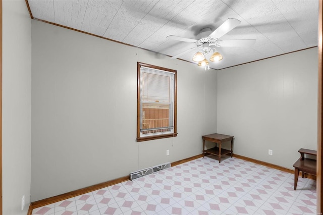 unfurnished room with a ceiling fan, crown molding, baseboards, and light flooring