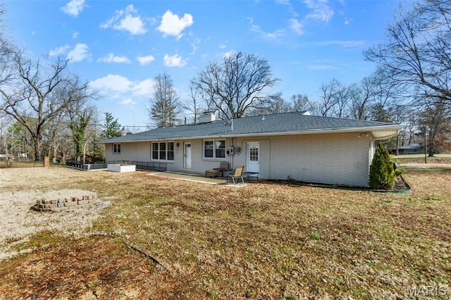 1331 N Cape Rock Dr, Cape Girardeau, MO 63701 - back of house with a patio, brick siding, a chimney, and a lawn