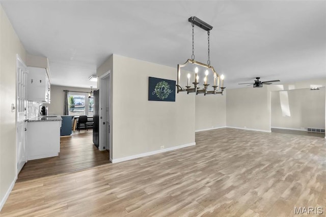 1331 N Cape Rock Dr, Cape Girardeau, MO 63701 - spare room featuring light wood-type flooring, ceiling fan, a chandelier, and baseboards