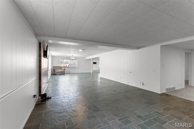 1331 N Cape Rock Dr, Cape Girardeau, MO 63701 - unfurnished living room featuring wood walls and baseboards
