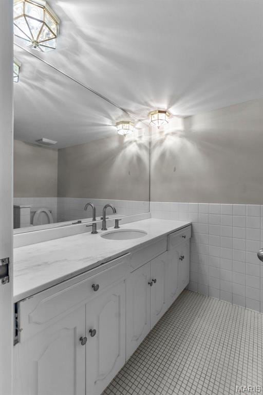 1331 N Cape Rock Dr, Cape Girardeau, MO 63701 - bathroom featuring tile walls, vanity, and tile patterned flooring