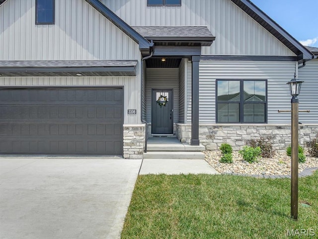 3106 Ashley Dr, Glen Carbon, IL 62034 - view of front of house featuring stone siding, driveway, and board and batten siding