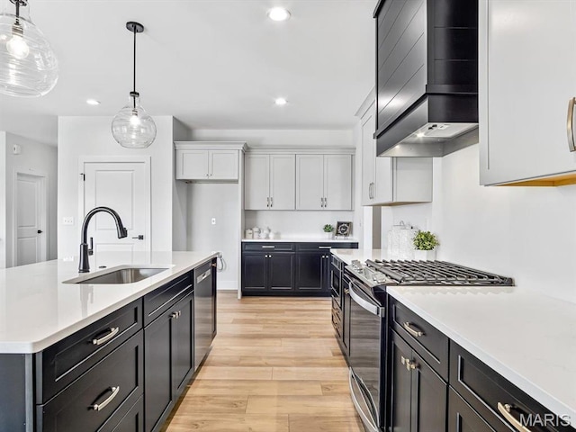 3106 Ashley Dr, Glen Carbon, IL 62034 - kitchen with range with gas stovetop, a sink, wall chimney exhaust hood, stainless steel dishwasher, and light countertops