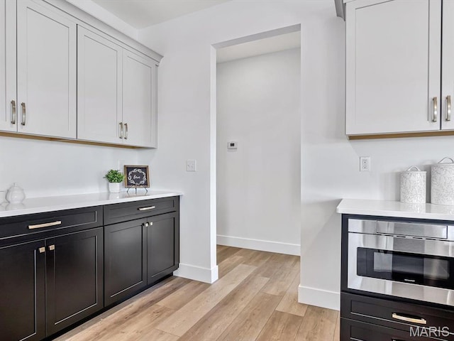 3106 Ashley Dr, Glen Carbon, IL 62034 - kitchen with light countertops, light wood finished floors, and baseboards
