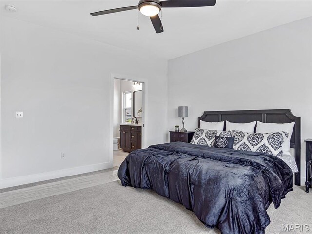 3106 Ashley Dr, Glen Carbon, IL 62034 - bedroom with light carpet, baseboards, ensuite bathroom, a ceiling fan, and a sink