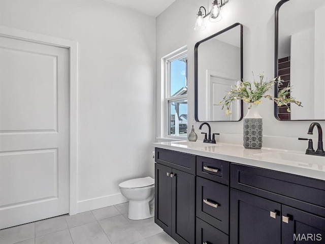3106 Ashley Dr, Glen Carbon, IL 62034 - full bathroom with tile patterned floors, toilet, double vanity, and baseboards