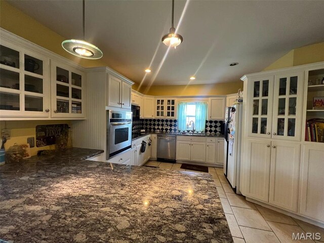 1001 S Main St, Lockwood, MO 65682 - kitchen featuring stainless steel appliances, light tile patterned flooring, a sink, backsplash, and a peninsula