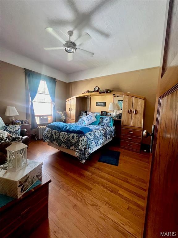 1001 S Main St, Lockwood, MO 65682 - bedroom featuring radiator, wood finished floors, and a ceiling fan