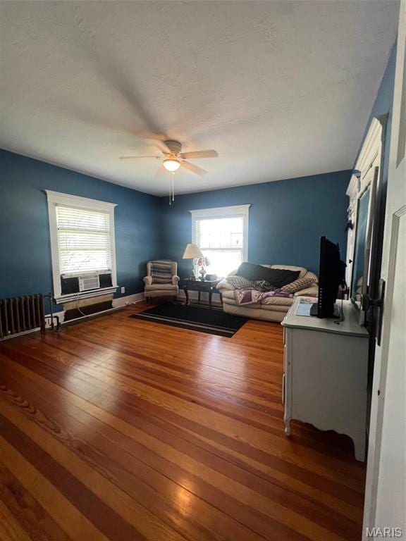 1001 S Main St, Lockwood, MO 65682 - living room featuring radiator heating unit, wood finished floors, and ceiling fan