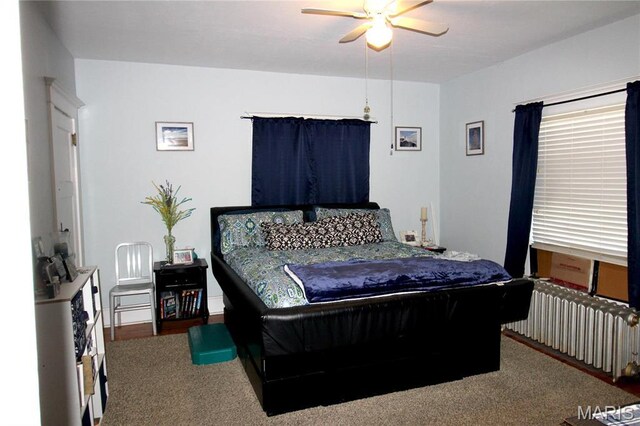 1001 S Main St, Lockwood, MO 65682 - carpeted bedroom with radiator heating unit and a ceiling fan