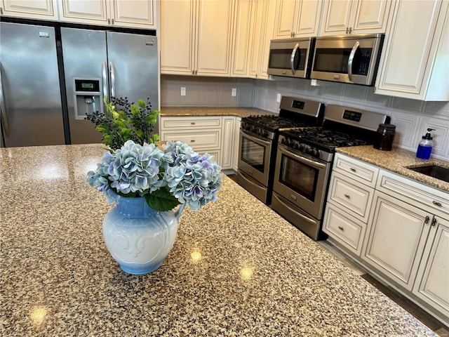 14305 State Highway F, Canton, MO 63435 - kitchen with stainless steel appliances, stone countertops, and tasteful backsplash
