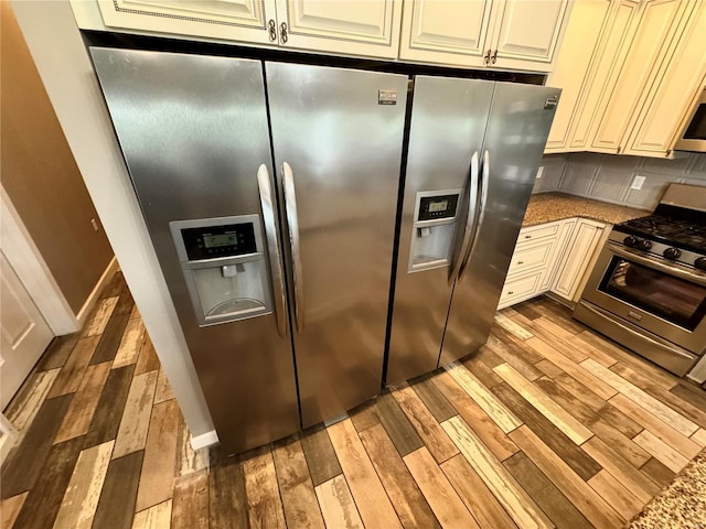 14305 State Highway F, Canton, MO 63435 - kitchen with appliances with stainless steel finishes, light wood-style floors, stone countertops, and cream cabinets