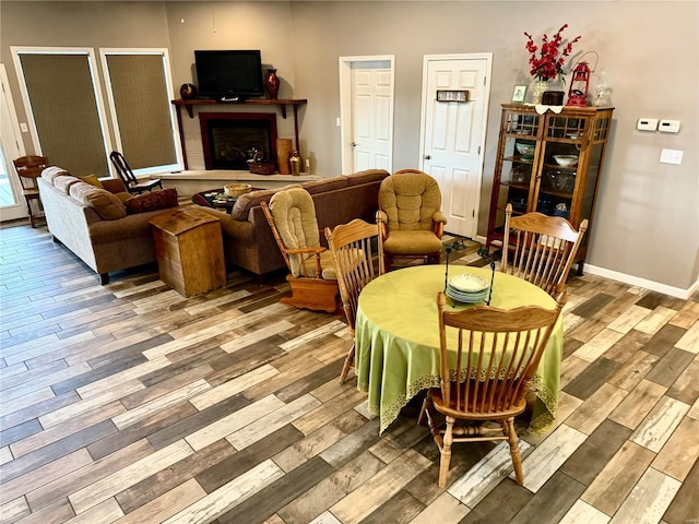 14305 State Highway F, Canton, MO 63435 - dining area featuring wood finished floors, a fireplace with raised hearth, and baseboards