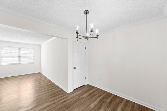 1509 Swallow Dr, Saint Louis, MO 63144 - unfurnished dining area featuring a chandelier, a textured ceiling, dark wood-style floors, ornamental molding, and baseboards