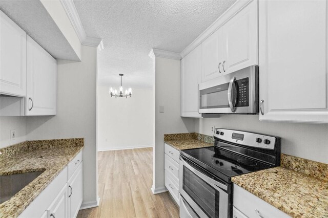 1509 Swallow Dr, Saint Louis, MO 63144 - kitchen with stainless steel appliances, a chandelier, light wood finished floors, white cabinetry, and a textured ceiling
