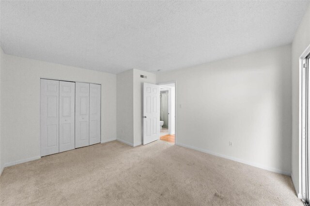1509 Swallow Dr, Saint Louis, MO 63144 - unfurnished bedroom with carpet floors, baseboards, a textured ceiling, and a closet