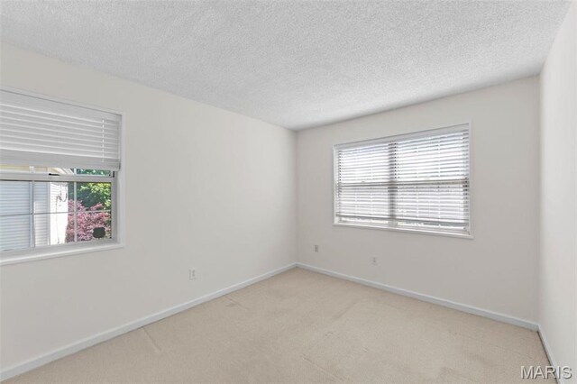 1509 Swallow Dr, Saint Louis, MO 63144 - carpeted empty room featuring baseboards and a textured ceiling