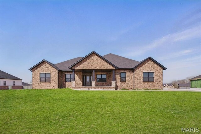 craftsman-style home featuring brick siding and a front lawn